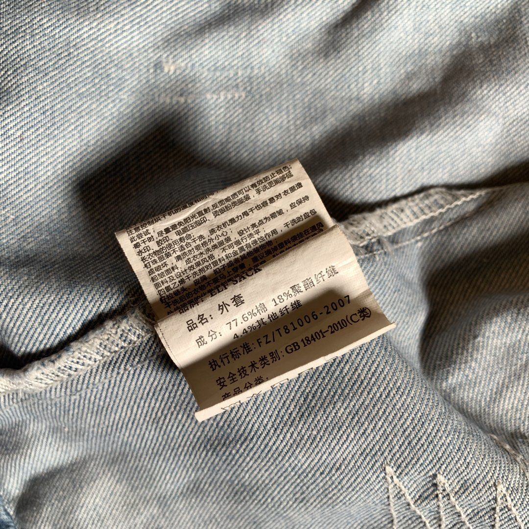 Elf Sack distressed denim jacket with decorative stitching (Category: Coats, Jackets and Outerwear) located in Rizal. Submitted by shop_ms.lai (Listing ID 1464972477, Image 3). Description: - Brand: Elf Sack - Style: Light wash denim jacket with distressed patches and metal studs - Details: Contrast orange stitching and button-front closure with dark buttons - Lining: Beautiful floral print inner lining - Material: 77.6% cotton - Fit: Great state
