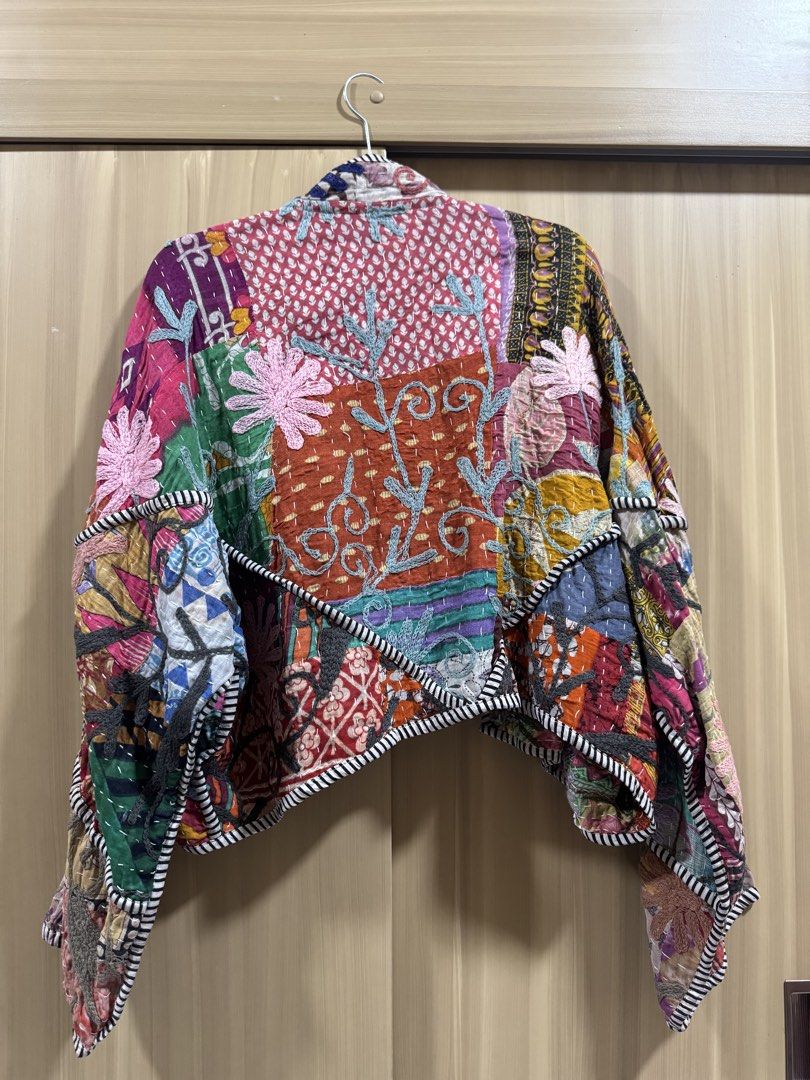 Elinora Kaia Jacket (Category: Coats, Jackets and Outerwear) located in Manila. Submitted by declutterdoctor (Listing ID 1465012814, Image 3). Description: - Brand: Elinora - Design: Colorful multi-pattern patchwork with kantha stitch detailing - Fit: Open front, cropped length, and loose batwing sleeves - Details: Striped piping along the collar, hem, and cuffs - Versatility: Reversible design featuring a different patchwork layout on each side 