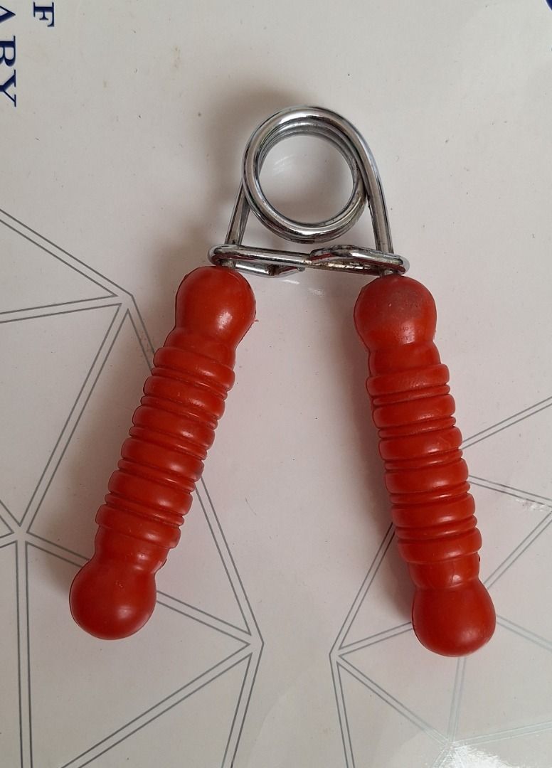 EXERCISER Hand Grip (Category: Toning & Stretching Accessories) located in General Trias. Submitted by aeunice (Listing ID 1465011747, Image 2). Description: In Good Condition. Hand grip strengthener for building forearm and hand power. Features a sturdy metal coil spring and comfortable textured red handles. Compact and portable for the gym or office. Meet up / Shipping via Lalamove, J&T, Gogo Express and LBC.