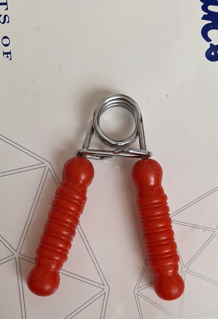 EXERCISER Hand Grip (Category: Toning & Stretching Accessories) located in General Trias. Submitted by aeunice (Listing ID 1465011747, Image 1). Description: In Good Condition. Hand grip strengthener for building forearm and hand power. Features a sturdy metal coil spring and comfortable textured red handles. Compact and portable for the gym or office. Meet up / Shipping via Lalamove, J&T, Gogo Express and LBC.