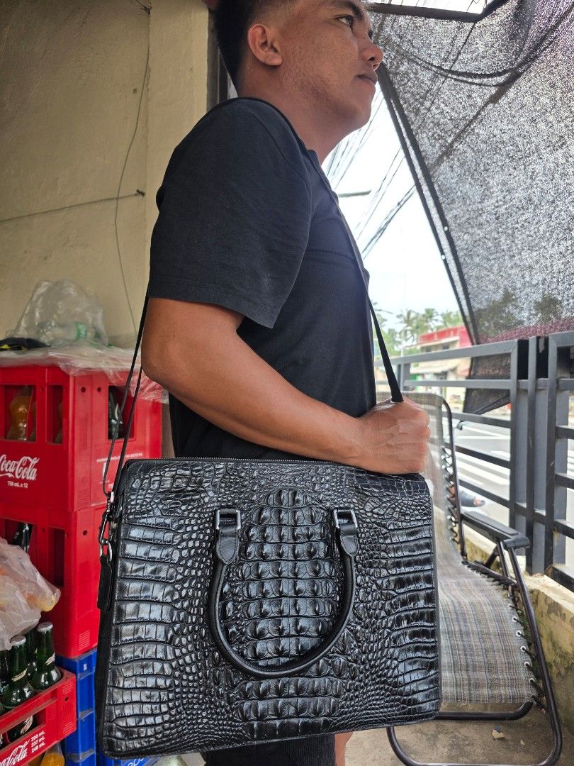 Faniya Black Crocodile Embossed Leather Briefcase (Category: Briefcases) located in Lemery. Submitted by venus23 (Listing ID 1465117689, Image 2). Description: - Brand: Faniya - Color: Classic Black - Material: Glossy crocodile embossed leather - Size: Roughly 15 inches across - Handles: Twin top carry handles + detachable shoulder strap - Closure: Secure top zip closure - Interior: Printed fabric lining with a convenient zippered pocket and bran