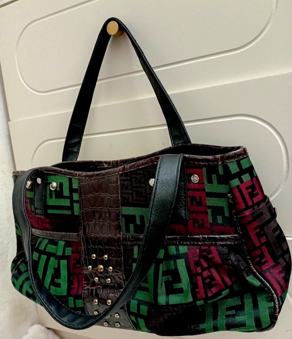 Fendi Geometric Pattern Tote Shoulder/hand bag (Category: Luxury Bags & Wallets) located in Navotas City. Submitted by ms.soulana (Listing ID 1464979010, Image 1). Description: PreOwned Lightly Used Fendi Multi Color Geometric Pattern Shoulder /handbag - Design: Green, burgundy, and dark brown geometric block pattern with a faux-crocodile center panel - Accents: Silver-tone rivets on black shoulder handles and small gold studs - Pockets: Exterior