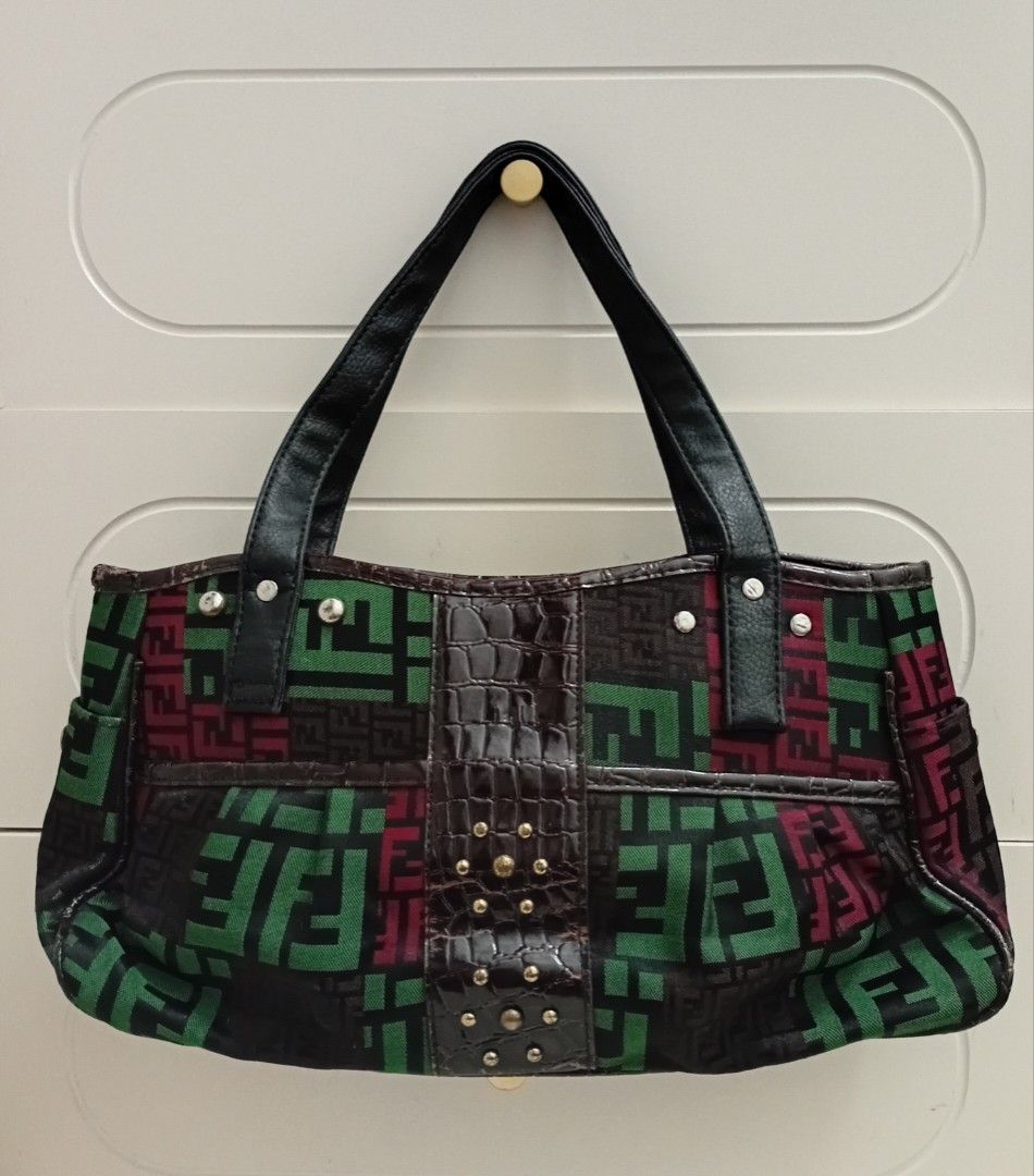 Fendi Geometric Pattern Tote Shoulder/hand bag (Category: Luxury Bags & Wallets) located in Navotas City. Submitted by ms.soulana (Listing ID 1464979010, Image 2). Description: PreOwned Lightly Used Fendi Multi Color Geometric Pattern Shoulder /handbag - Design: Green, burgundy, and dark brown geometric block pattern with a faux-crocodile center panel - Accents: Silver-tone rivets on black shoulder handles and small gold studs - Pockets: Exterior