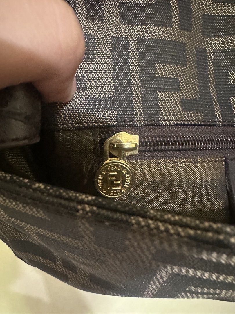 Fendi Zucchino FF Canvas Shoulder Bag (Category: Luxury Bags & Wallets) located in Tagum. Submitted by ritarits572 (Listing ID 1464978859, Image 3). Description: - Fendi shoulder bag in iconic black and grey Zucchino canvas with FF monogram pattern - Adjustable leather strap for a comfortable, customizable fit - Front flap closure with secure magnetic snap and engraved hardware - Spacious interior featuring a zippered pocket with Fendi logo pull 