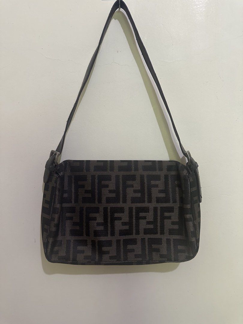 Fendi Zucchino FF Canvas Shoulder Bag (Category: Luxury Bags & Wallets) located in Tagum. Submitted by ritarits572 (Listing ID 1464978859, Image 2). Description: - Fendi shoulder bag in iconic black and grey Zucchino canvas with FF monogram pattern - Adjustable leather strap for a comfortable, customizable fit - Front flap closure with secure magnetic snap and engraved hardware - Spacious interior featuring a zippered pocket with Fendi logo pull 