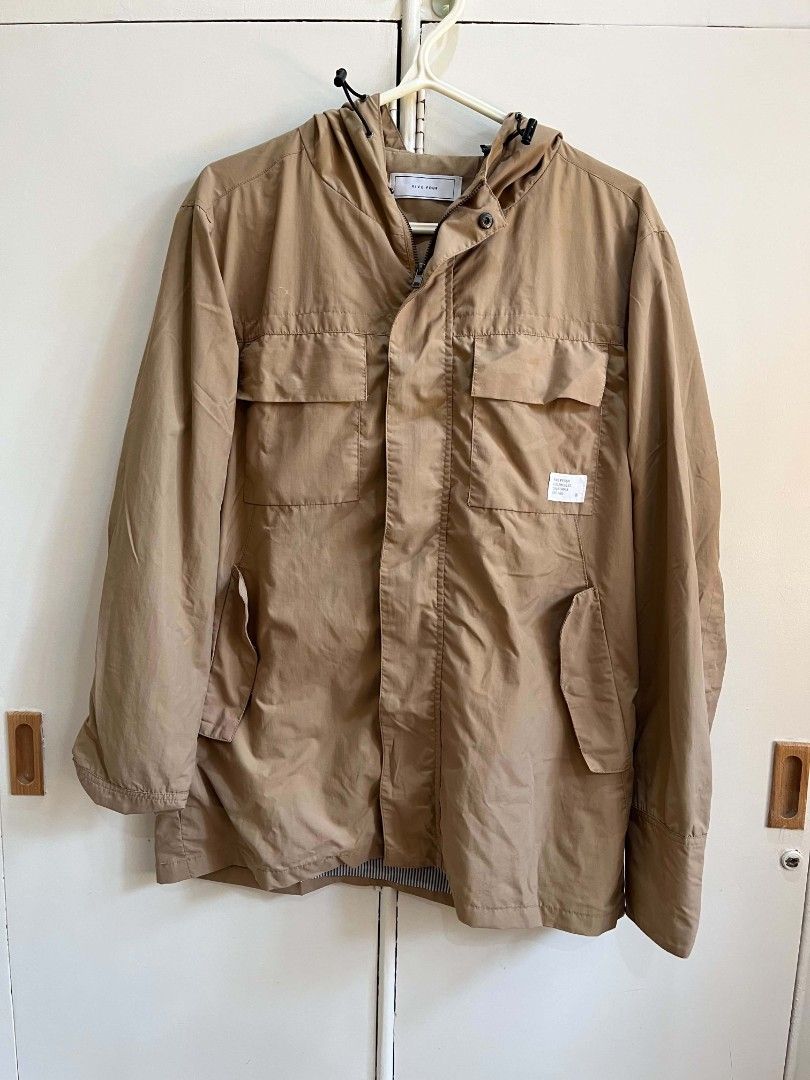 Five Four Tan Hooded Utility Jacket (Category: Coats, Jackets and Outerwear) located in Iloilo. Submitted by franzventures (Listing ID 1464985553, Image 2). Description: Nine Four jacket in tan. Hooded style with adjustable pull cords. Zipper front closure plus snap buttons down the placket. Dual chest flap pockets and side hand pockets. Striped fabric lining inside. White branded patch on the left chest pocket. Lightweight outer fabric, great tr