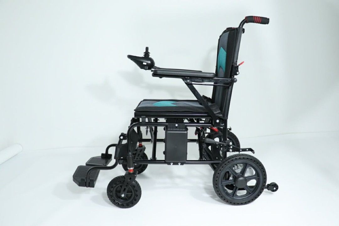 Foldable Electric Wheelchair with Joystick Controller and Battery Pack (Category: Wheelchairs) located in Caloocan City. Submitted by marcusalde44223 (Listing ID 1465021223, Image 1). Description: - Color: Black frame with stylish teal and grey cushioned seating - Control: Built-in right armrest joystick - Performance: Dual rear motors with large rear wheels and front casters - Comfort & Safety: Fold-away footrests, safety lap belt, and under-sea