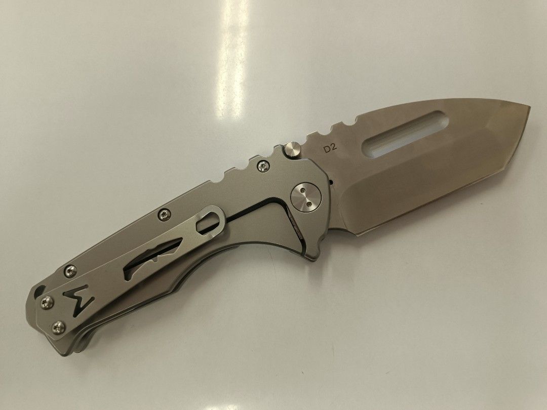 Folding Knife - Medford Praetorian - Clone Only (Category: Knives & Chopping Boards) located in Bacolod City. Submitted by viclawrence (Listing ID 1464976694, Image 1). Description: - Blade Material: D2 steel for durability and edge retention - Handle: Titanium-colored with ergonomic finger grooves for a comfortable grip - Deployment: Dual thumb studs for fast, smooth one-handed opening - Safety: Reliable lock mechanism keeps the blade securely i