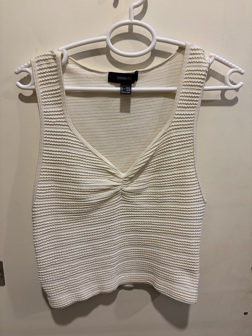 Forever 21+ Textured Knit Tank Top (Category: Sleeveless) located in Quezon City. Submitted by js.preloved_lcsn (Listing ID 1465013129, Image 1). Description: - Brand: Forever 21+ - Style: Textured knit tank top with front twist detail - Color: Cream - Size: Plus Size 0X/1X - Neckline: Scoop neck - Details: Sleeveless cut, ribbed texture throughout .