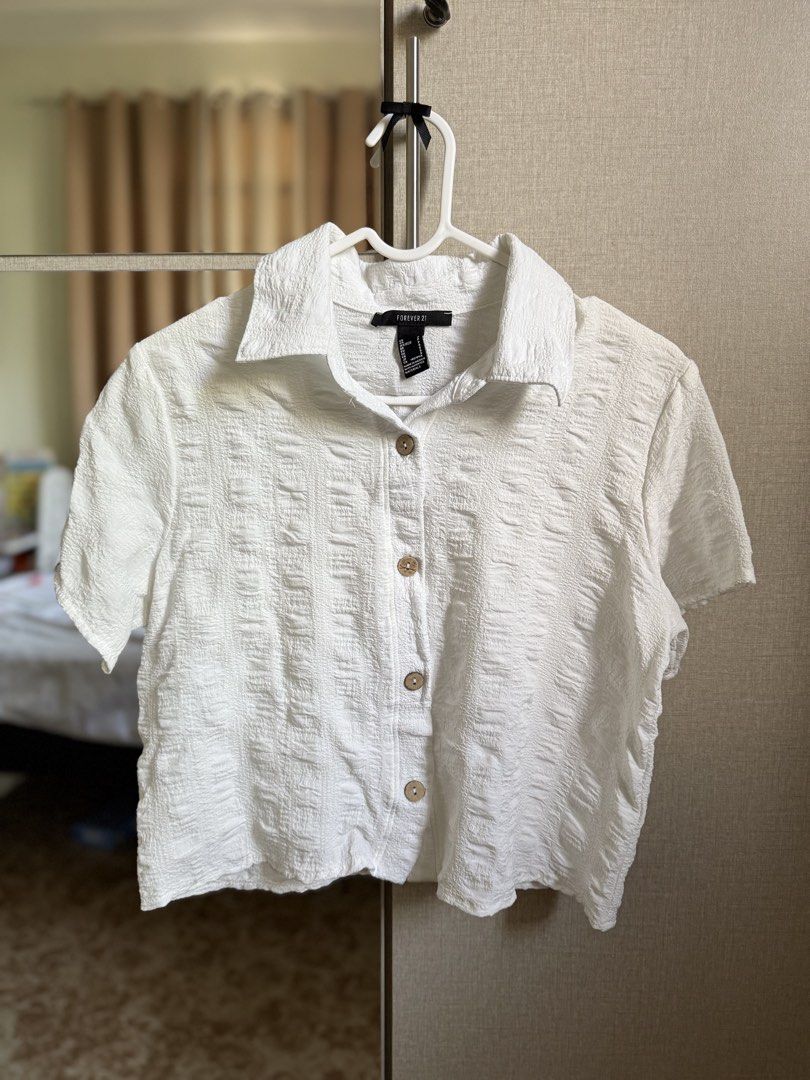 Forever 21 White Textured Button-Up Blouse Shirt (Category: Blouses) located in Angeles City. Submitted by decluttering.kimmmyyy (Listing ID 1465044481, Image 1). Description: - Forever 21 White Collared Shirt - Used once .