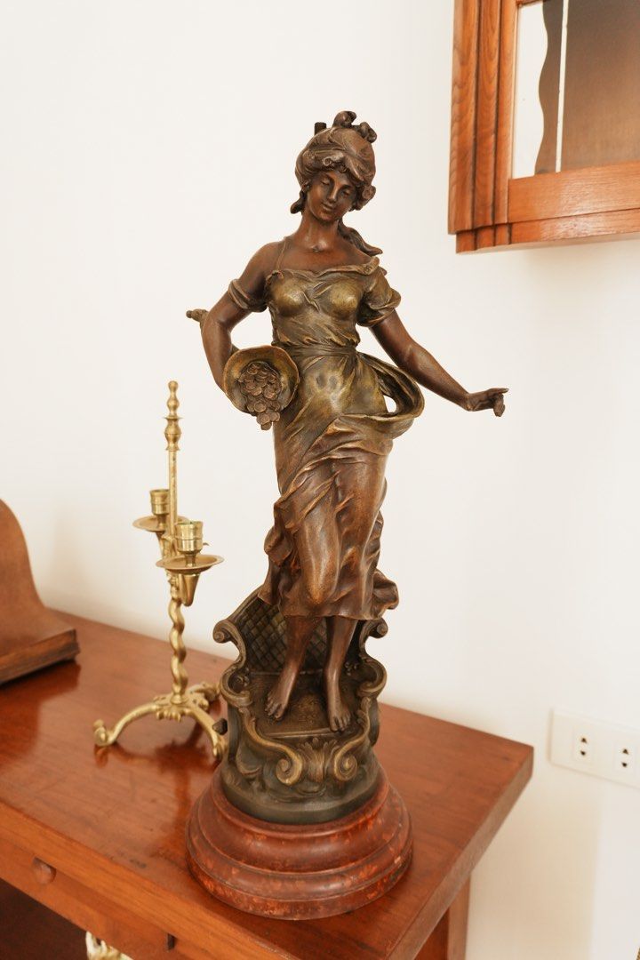 Fortune & Abundance - Decorative Female Figure (Category: Vintage Collectibles) located in Manila. Submitted by heleensym (Listing ID 1464970010, Image 1). Description: A graceful allegorical figure holding a horn of plenty overflowing with coins, symbolising prosperity and good fortune. Flowing drapery and warm bronze-coloured and gold-toned finishes complement an ornate scrollwork pedestal and stepped circular base. An expressive decorative acc