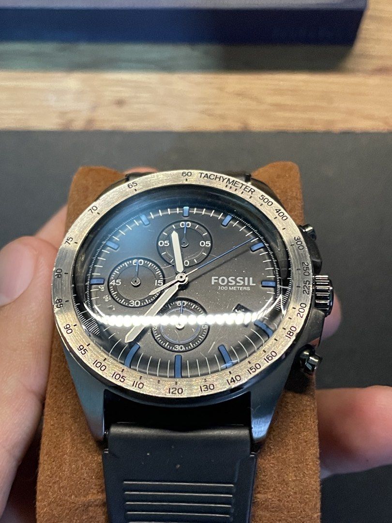 Fossil 100 Meters Chronograph Watch (Category: Men's Watches) located in San Carlos. Submitted by kedecop (Listing ID 1465081319, Image 3). Description: - Brand: Fossil - Style: Chronograph watch - Dial: Textured black with striking blue markers and 3 sub-dials - Bezel: Tachymeter bezel - Date Display: Located near the 4 o'clock position - Strap: Durable textured rubber strap with buckle closure - Condition: Well-maintained, ready to wear - Perfe