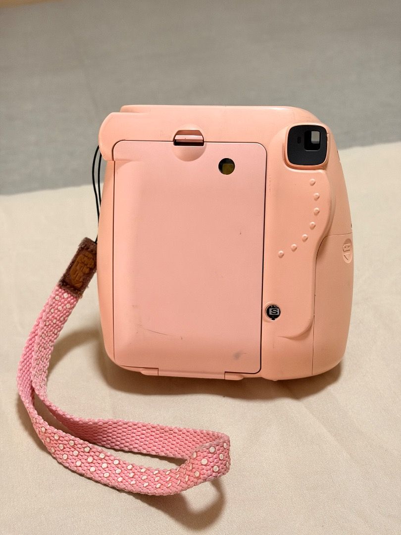Fujifilm Instax Mini 8 Pink Instant Camera with Strap (Category: Cameras) located in Manila. Submitted by quekrystel35491 (Listing ID 1464990923, Image 2). Description: - Model: Fujifilm Instax Mini 8 in a cute pink color - Lens: 60mm focus range for clear everyday snaps - Flash: Built-in front flash for low-light shots - Extras: Includes a matching pink patterned wrist strap - Perfect for: Parties, trips, events, and instant analog photography e