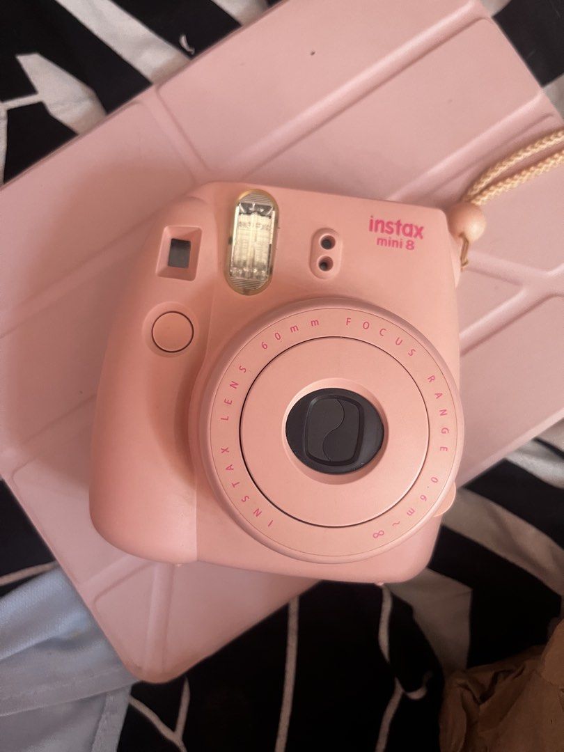 Fujifilm Instax Mini 8 Pink Instant Camera (Category: Cameras) located in Antipolo. Submitted by trix.0429 (Listing ID 1465030911, Image 1). Description: - Authentic Fujifilm Instax Mini 8 in a cute pink shade - Compact and lightweight body with an attached wrist strap - Built-in flash located right above the lens for easy low-light shooting - Simple manual exposure adjustment ring around the lens barrel - Clean exterior plastic shell with a prop