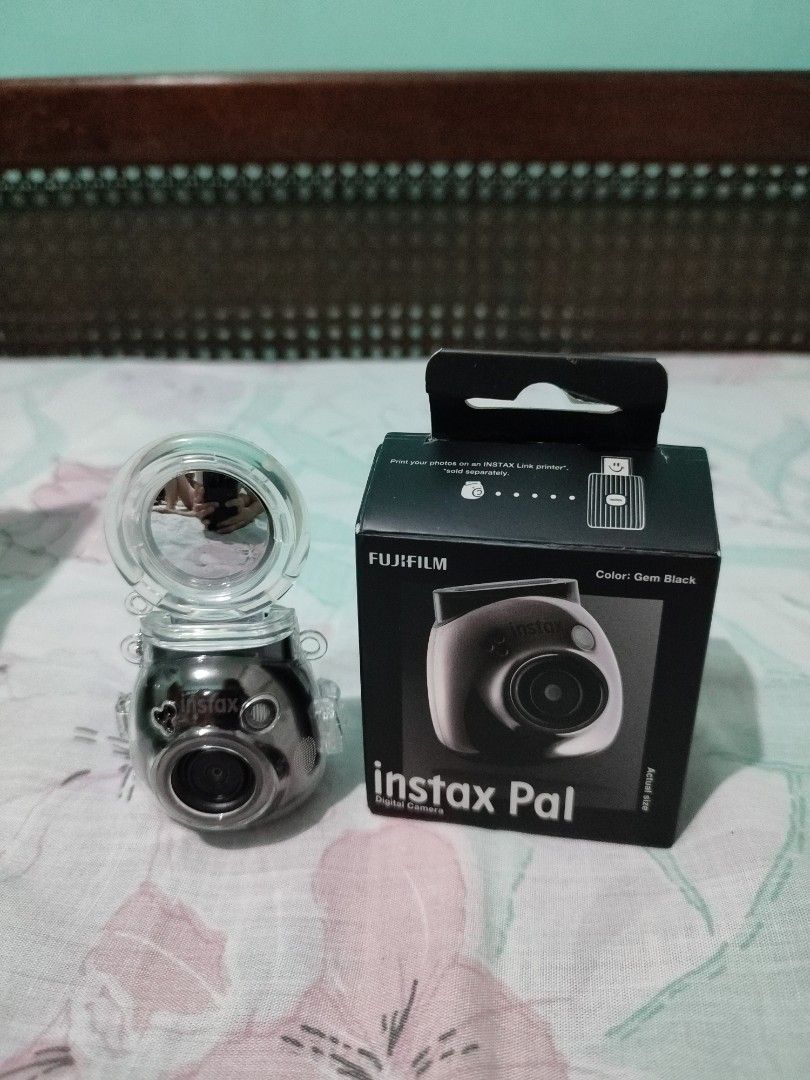 Fujifilm instax pal (Category: Cameras) located in Noveleta. Submitted by preloved__items___ (Listing ID 1465091204, Image 1). Description: - Brand: Fujifilm - Model: Instax Pal Digital Camera - Color: Gem Black - Condition: Excellent, complete with box - Inclusions: USB charging cable, multi-use ring stand/strap, and clear protective case - Compact and portable design for everyday snapshots.
