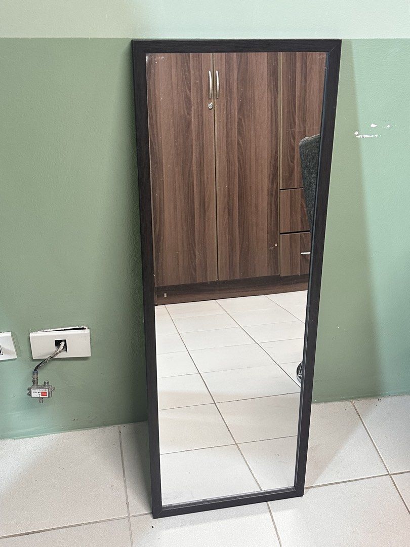 Full length rectangular mirror with dark wood frame (Category: Mirrors) located in Manila. Submitted by merylaloja98489 (Listing ID 1465038137, Image 1). Description: - Dark wood frame full-length mirror - Tall and narrow design, ideal for bedrooms or hallways.