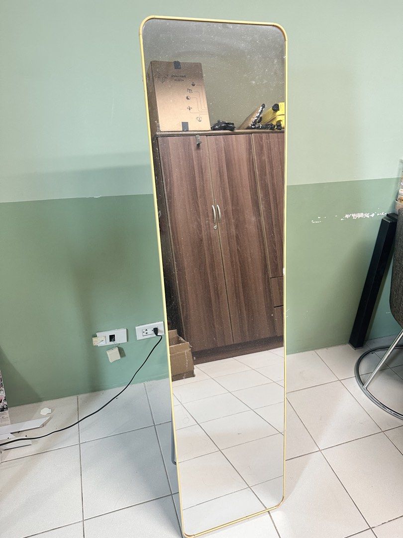 Full length standing mirror with yellow frame (Category: Mirrors) located in Manila. Submitted by merylaloja98489 (Listing ID 1465035792, Image 1). Description: - Tall standing mirror with a light yellow frame - Clean glass with zero cracks and a neat black backing board - Metal stand at the back that folds flat for easy storage and moving - Simple and minimalist design that fits bedrooms, hallways, or living room corners.