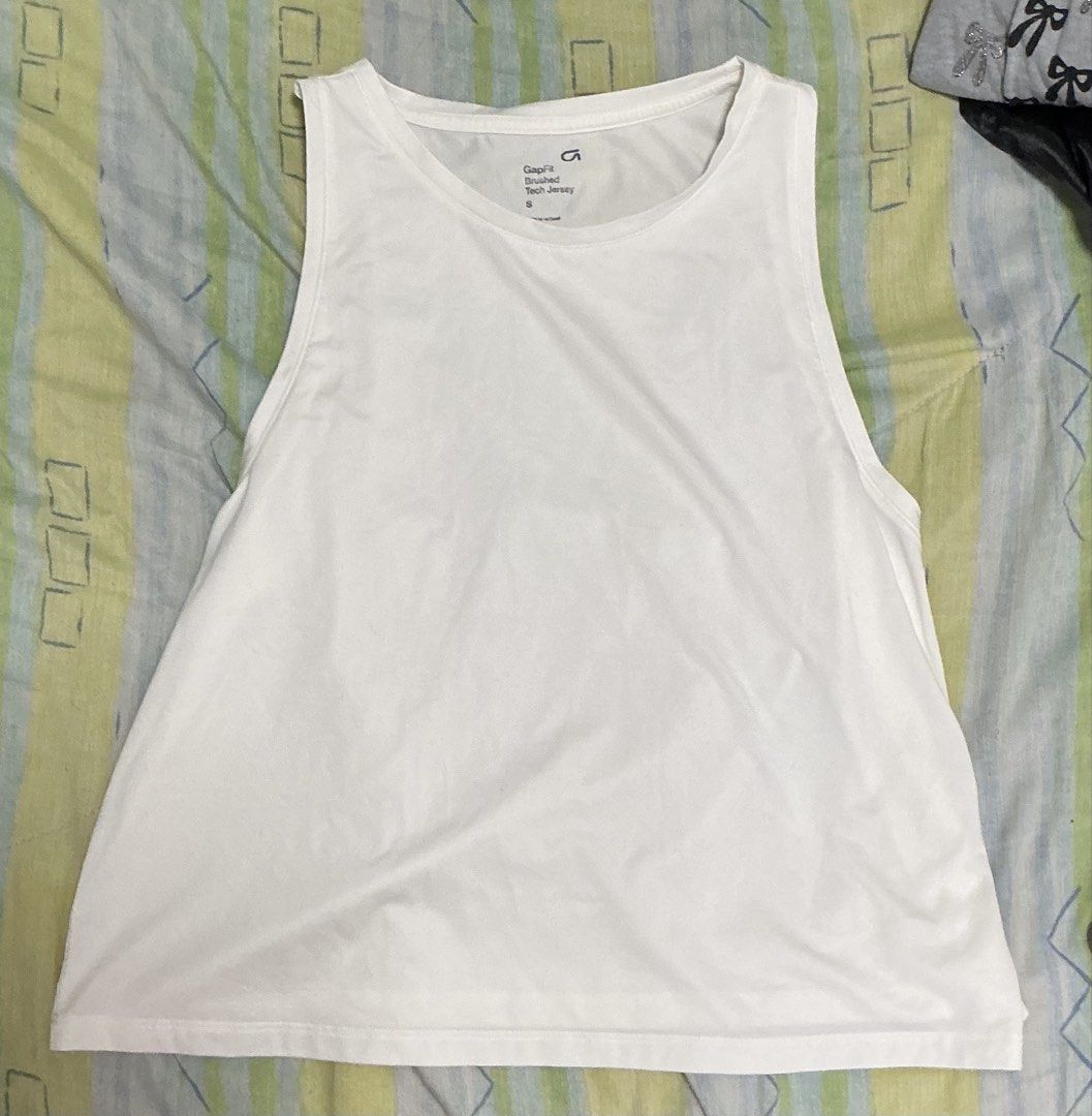GapFit Brushed Tech Jersey Tank Top White Size S (Category: Sleeveless) located in Manila. Submitted by mornight736 (Listing ID 1465007737, Image 1). Description: - Size: Small (tag printed inside collar) can fit M - Material: Lightweight workout fabric, sleeveless, relaxed hem - Condition: Great, no major flaws - MOP: Gcash + SF - SF is shouldered by buyer .