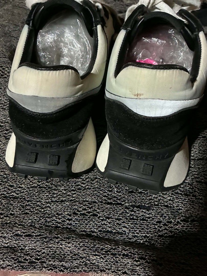 Givenchy Black and White Sneakers Size 41 (Category: Sneakers & Footwear) located in Nabunturan. Submitted by kairosas85 (Listing ID 1465112138, Image 3). Description: - Brand: Givenchy - Colorway: Classic Black and White - Size: 41 (stamped inside collar) - Design: Signature branding on tongue, side panel, and back heel counter - Sole: Chunky white midsole with durable black tread - Details: Laces with metallic hardware accents - Condition: Norm