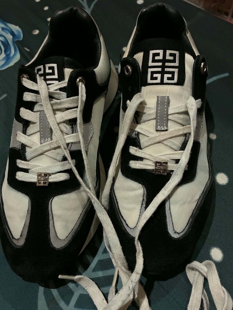 Givenchy Black and White Sneakers Size 41 (Category: Sneakers & Footwear) located in Nabunturan. Submitted by kairosas85 (Listing ID 1465112138, Image 1). Description: - Brand: Givenchy - Colorway: Classic Black and White - Size: 41 (stamped inside collar) - Design: Signature branding on tongue, side panel, and back heel counter - Sole: Chunky white midsole with durable black tread - Details: Laces with metallic hardware accents - Condition: Norm