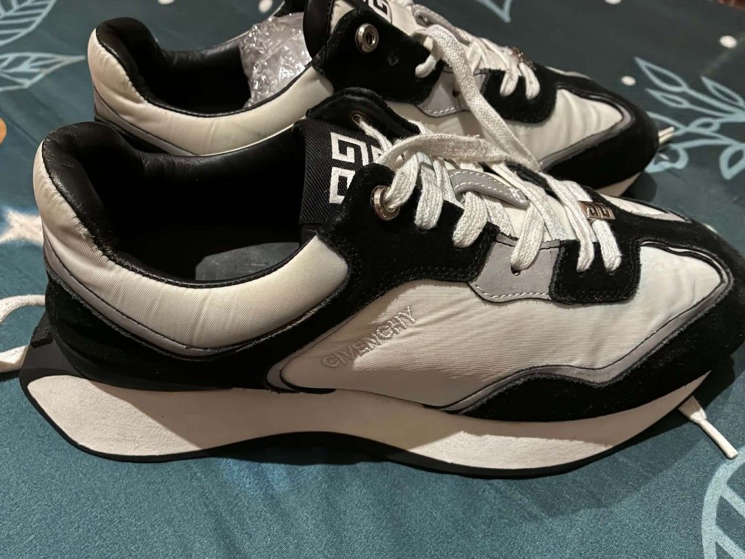 Givenchy Black and White Sneakers Size 41 (Category: Sneakers & Footwear) located in Nabunturan. Submitted by kairosas85 (Listing ID 1465112138, Image 2). Description: - Brand: Givenchy - Colorway: Classic Black and White - Size: 41 (stamped inside collar) - Design: Signature branding on tongue, side panel, and back heel counter - Sole: Chunky white midsole with durable black tread - Details: Laces with metallic hardware accents - Condition: Norm
