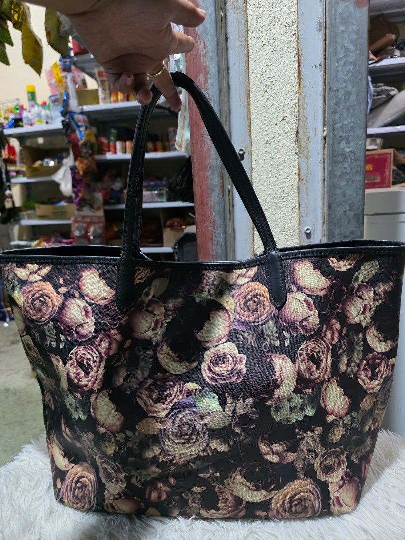 Givenchy Floral Tote Bag (Category: Tote Bags) located in Lemery. Submitted by venus23 (Listing ID 1465131779, Image 2). Description: -Givenchy floral tote bag with a striking dark rose pattern - Elegant black leather handles and trim for added durability - Spacious interior featuring a clean lining and convenient inner pocket - Generous size: measures approximately 15 inches across the bottom - Versatile design, perfect for work, school, or casu
