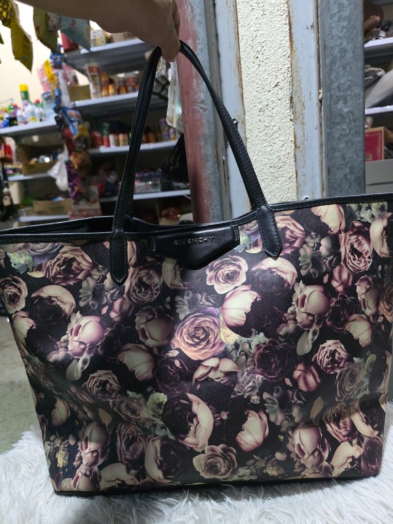 Givenchy Floral Tote Bag (Category: Tote Bags) located in Lemery. Submitted by venus23 (Listing ID 1465131779, Image 1). Description: -Givenchy floral tote bag with a striking dark rose pattern - Elegant black leather handles and trim for added durability - Spacious interior featuring a clean lining and convenient inner pocket - Generous size: measures approximately 15 inches across the bottom - Versatile design, perfect for work, school, or casu