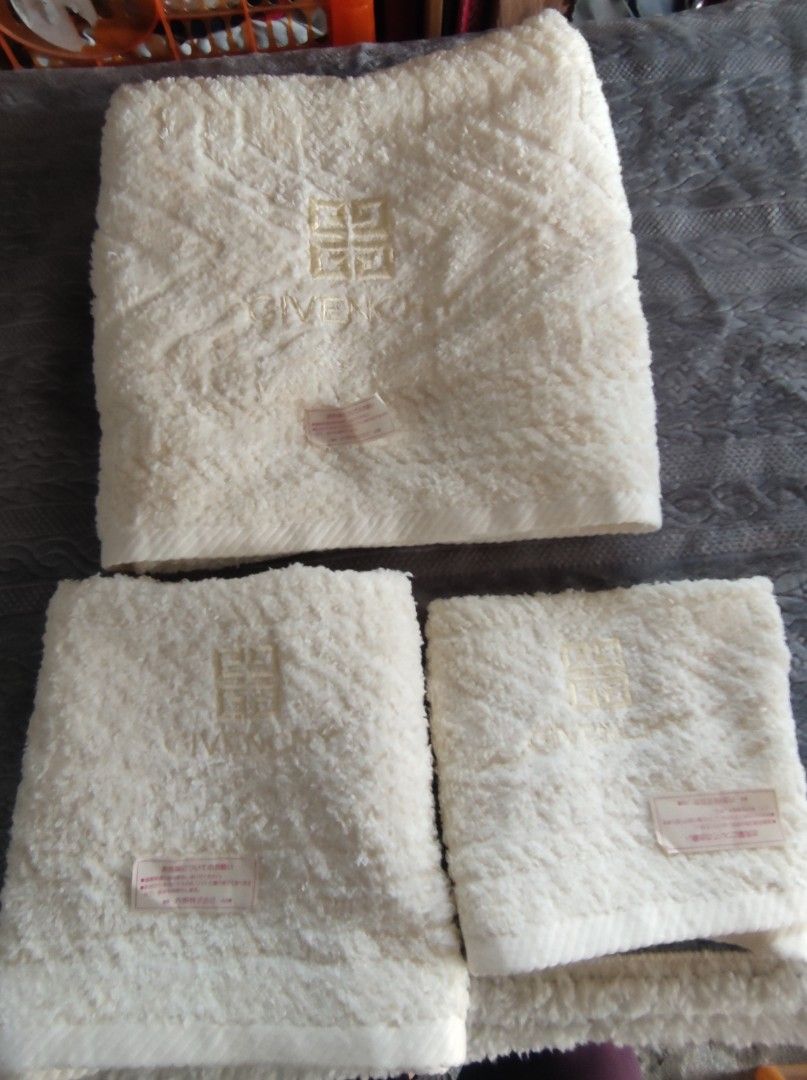 Givenchy Off-White Towel Set (Category: Bedding & Towels) located in Manila. Submitted by annetteasi22390 (Listing ID 1465011453, Image 1). Description: - Brand: Givenchy - Color: Creamy off-white - Set includes: 1 larger towel and smaller matching towels - Features: Textured pattern with embroidered logo and branding - Material: Soft plush fabric - Origin: Japanese care tags attached - Condition: Brand new / Great addition to any bathroom.