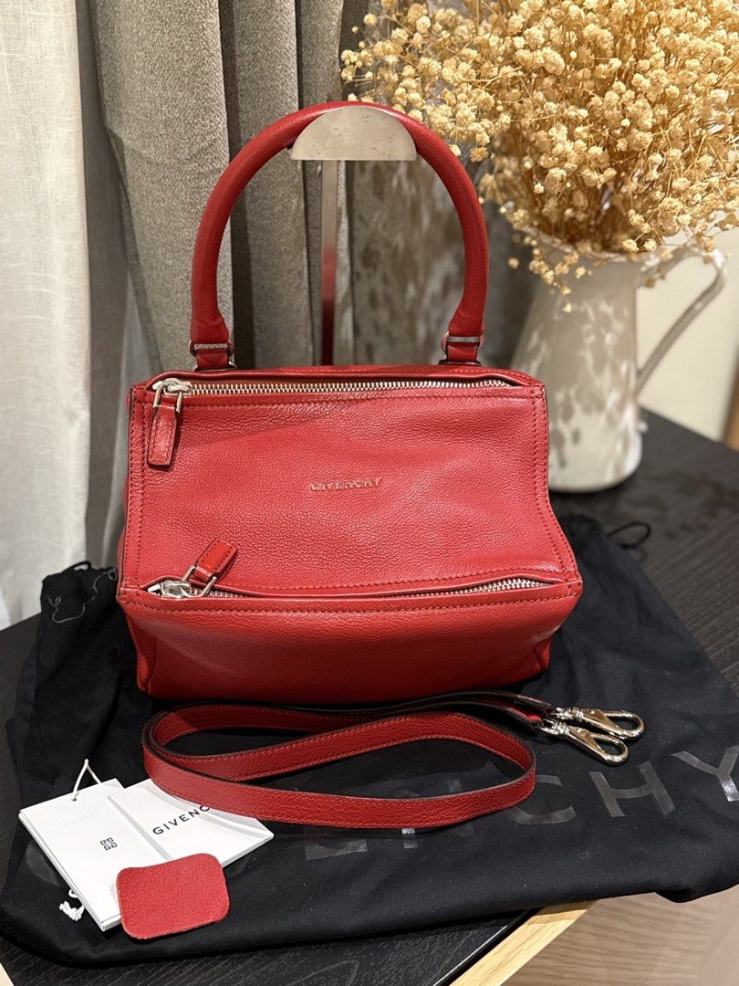 Givenchy Pandora Red Leather Handbag (Category: Luxury Bags & Wallets) located in Quezon City. Submitted by mamadeclutter8877 (Listing ID 1465085672, Image 1). Description: Givenchy Pandora bag in striking red textured leather. Includes the detachable shoulder strap, original dust bag, and store tags. Distinctive boxy shape with top zip closure and silver-tone hardware. Interior lined in neutral canvas with zip and slip pockets. Made in Italy. Gr
