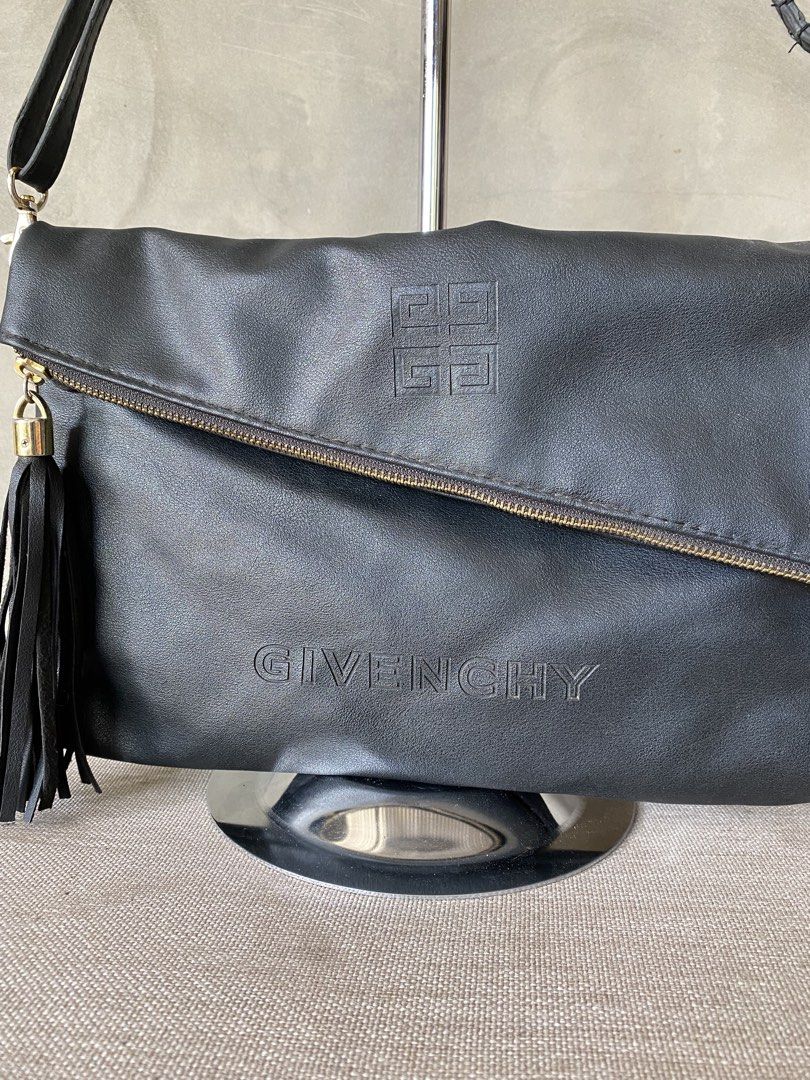 Givenchy VIP 2way Crossbody Bag (Category: Cross-body Bags) located in Manila. Submitted by why_notph (Listing ID 1465104590, Image 2). Description: - Brand: Parfums Givenchy - Material: 100% PU leather body with 100% polyester dark nylon lining - Color: Classic Black - Closure: Foldover front flap - Pockets: Exterior slanted zipper pocket and interior zip pocket - Accents: Detachable fringe tassel for a stylish touch - Strap: Adjustable shoulder