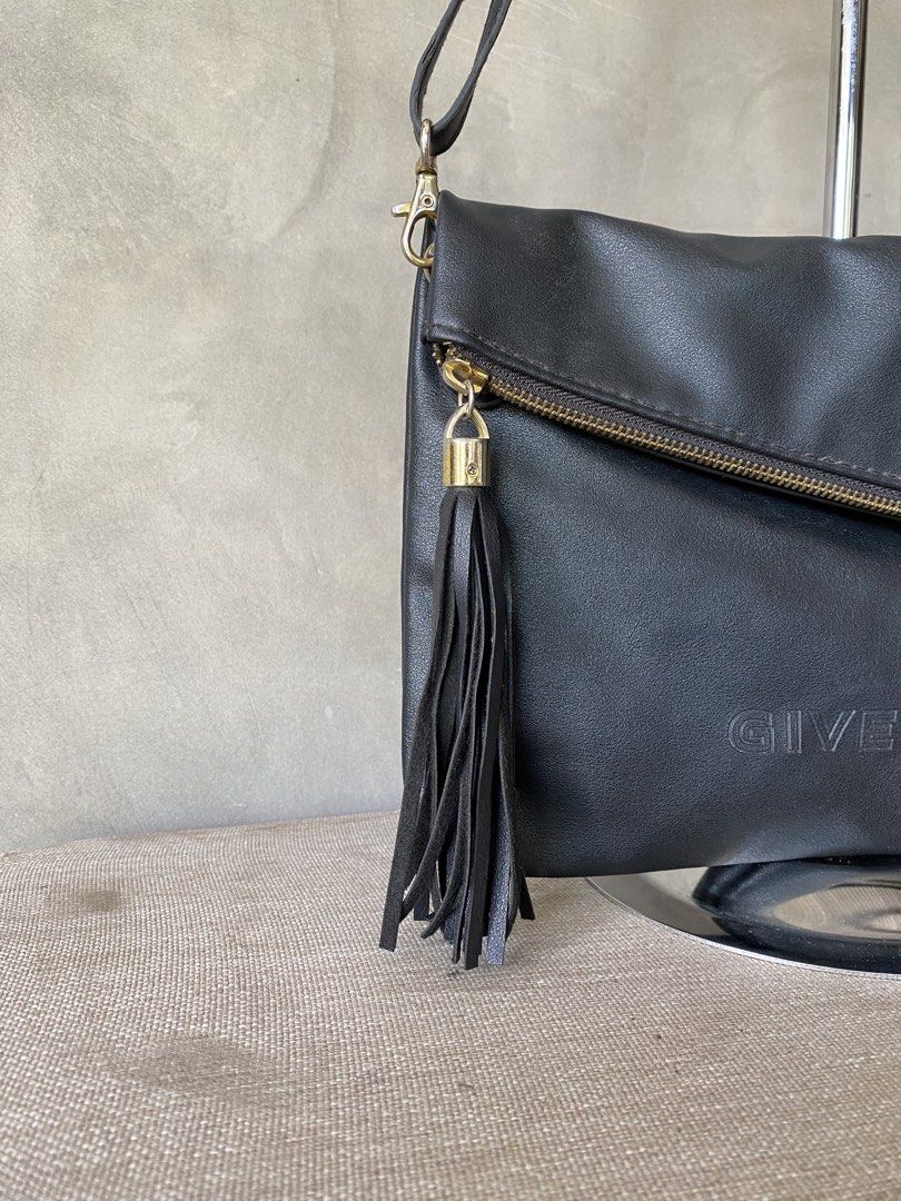 Givenchy VIP 2way Crossbody Bag (Category: Cross-body Bags) located in Manila. Submitted by why_notph (Listing ID 1465104590, Image 3). Description: - Brand: Parfums Givenchy - Material: 100% PU leather body with 100% polyester dark nylon lining - Color: Classic Black - Closure: Foldover front flap - Pockets: Exterior slanted zipper pocket and interior zip pocket - Accents: Detachable fringe tassel for a stylish touch - Strap: Adjustable shoulder