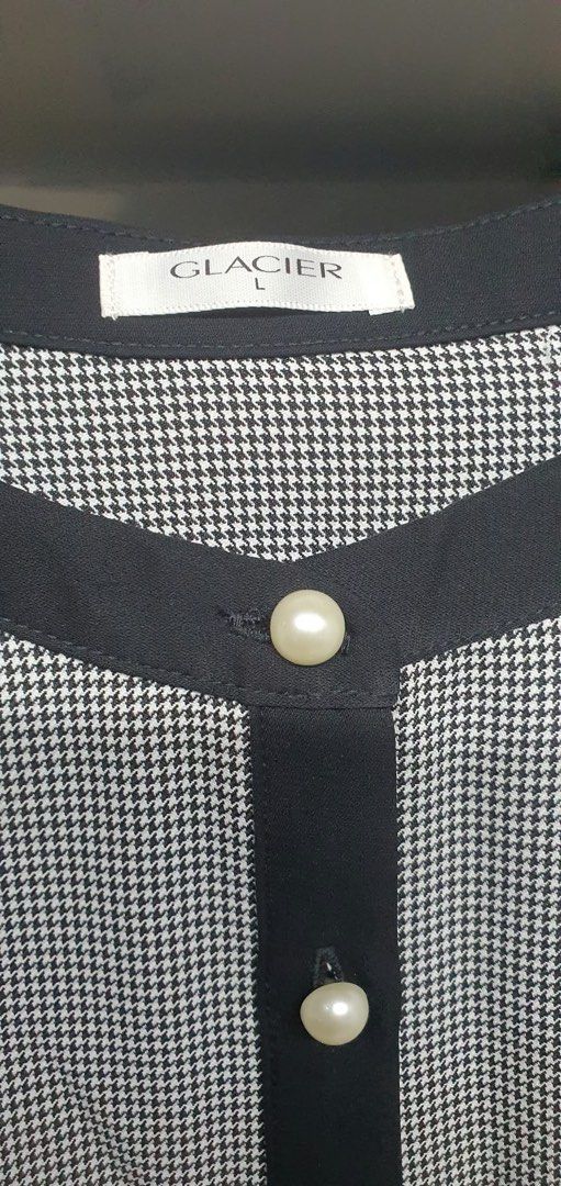 Glacier Black and White Houndstooth Blouse Size L (Category: Blouses) located in Manila. Submitted by apoltree (Listing ID 1465021136, Image 2). Description: - Brand: Glacier - Size: L - Material: 100% polyester - Pattern: Black and white houndstooth - Details: Solid black trim on neckline and placket, elegant faux-pearl front buttons - Condition: Clean and ready to wear.