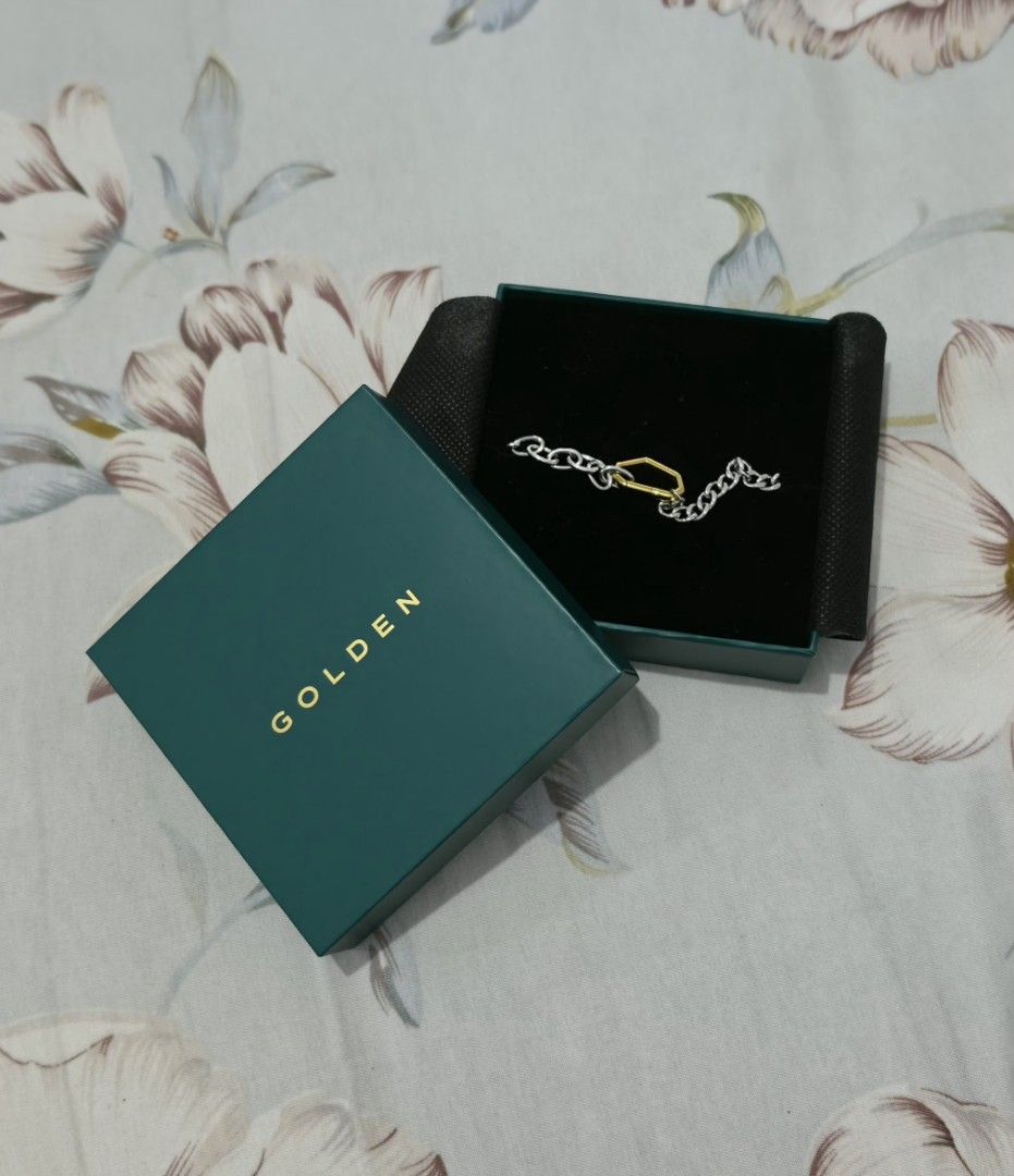 Golden Bracelet Jungkook JK (Category: Bracelets) located in Cavite. Submitted by ianney_mae (Listing ID 1465044673, Image 2). Description: - Brand: GOLDEN bought from Weverse - Design: Two-tone chain with silver links and a gold-toned geometric center link - Condition: Like new, worn once. - Packaging: Original packaging.