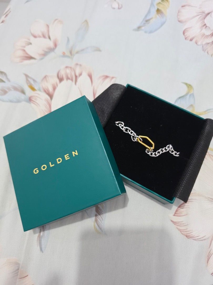 Golden Bracelet Jungkook JK (Category: Bracelets) located in Cavite. Submitted by ianney_mae (Listing ID 1465044673, Image 1). Description: - Brand: GOLDEN bought from Weverse - Design: Two-tone chain with silver links and a gold-toned geometric center link - Condition: Like new, worn once. - Packaging: Original packaging.