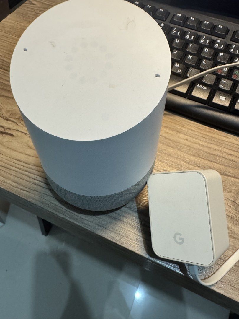 Google Home Smart Speaker (Category: Soundbars, Speakers & Amplifiers) located in Cavite. Submitted by marcuz1316 (Listing ID 1465158363, Image 2). Description: - Authentic Google Home smart speaker in stylish white and grey fabric - Fully tested and powers on normally with active LED lights - Includes official power adapter plug - Compact design fits perfectly on any desk or table - Condition: Used with minor dust and light scuffs on the top sur