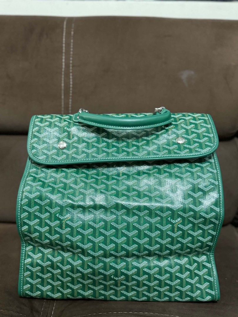 Goyard Green Saigon Backpack (Category: Backpacks) located in Dagupan City. Submitted by calligenia (Listing ID 1464997641, Image 1). Description: Goyard backpack in green chevron canvas. Leather top handle and adjustable shoulder straps. Front flap with turn-lock closure plus side zipper entry. Silver-tone hardware. Vibrant yellow fabric interior lining with some visible staining throughout. Debossed Goyard Paris logo stamp inside. Measures medi