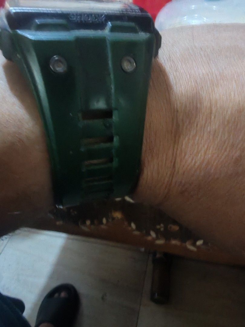 Green digital watch with rugged strap design (Category: Men's Watches) located in Manila. Submitted by hassanalsa47489 (Listing ID 1464977295, Image 1). Description: Army green digital watch on wrist. Thick rubber strap with rectangular cutouts along the band. Two small silver screws on each side of the strap near the watch case. Dark bezel case with some wear marks. Functional everyday timepiece, easy to strap on..
