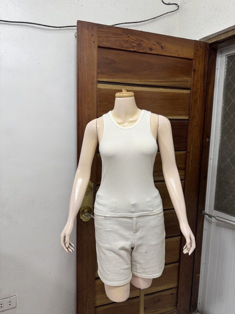 GU White Tank Top Ribbed Cotton Size M (Category: Sleeveless) located in Cavite. Submitted by yakultjeni85475 (Listing ID 1465123981, Image 3). Description: - Style: Classic white ribbed tank top - Size: Medium (M) - Material: Lightweight, stretchy cotton - Design: Scoop neckline, sleeveless - Condition: Clean with no major flaws - Versatility: Perfect for layering or everyday wear.