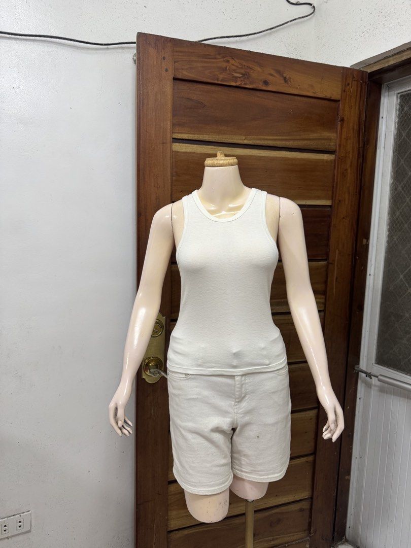 GU White Tank Top Ribbed Cotton Size M (Category: Sleeveless) located in Cavite. Submitted by yakultjeni85475 (Listing ID 1465123981, Image 2). Description: - Style: Classic white ribbed tank top - Size: Medium (M) - Material: Lightweight, stretchy cotton - Design: Scoop neckline, sleeveless - Condition: Clean with no major flaws - Versatility: Perfect for layering or everyday wear.