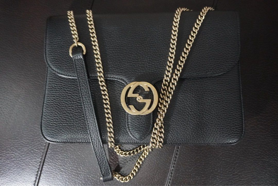 Gucci Black Leather Shoulder Bag (Category: Luxury Bags & Wallets) located in Paranaque City. Submitted by egg_shells (Listing ID 1465052566, Image 2). Description: - Brand: Gucci - Material: Premium black grained leather - Hardware: Elegant light gold-tone chain strap and iconic interlocking GG front closure - Interior: Light-colored fabric lining with multiple compartments and a secure zip pocket - Design: Clean, structured, and timeless shape 