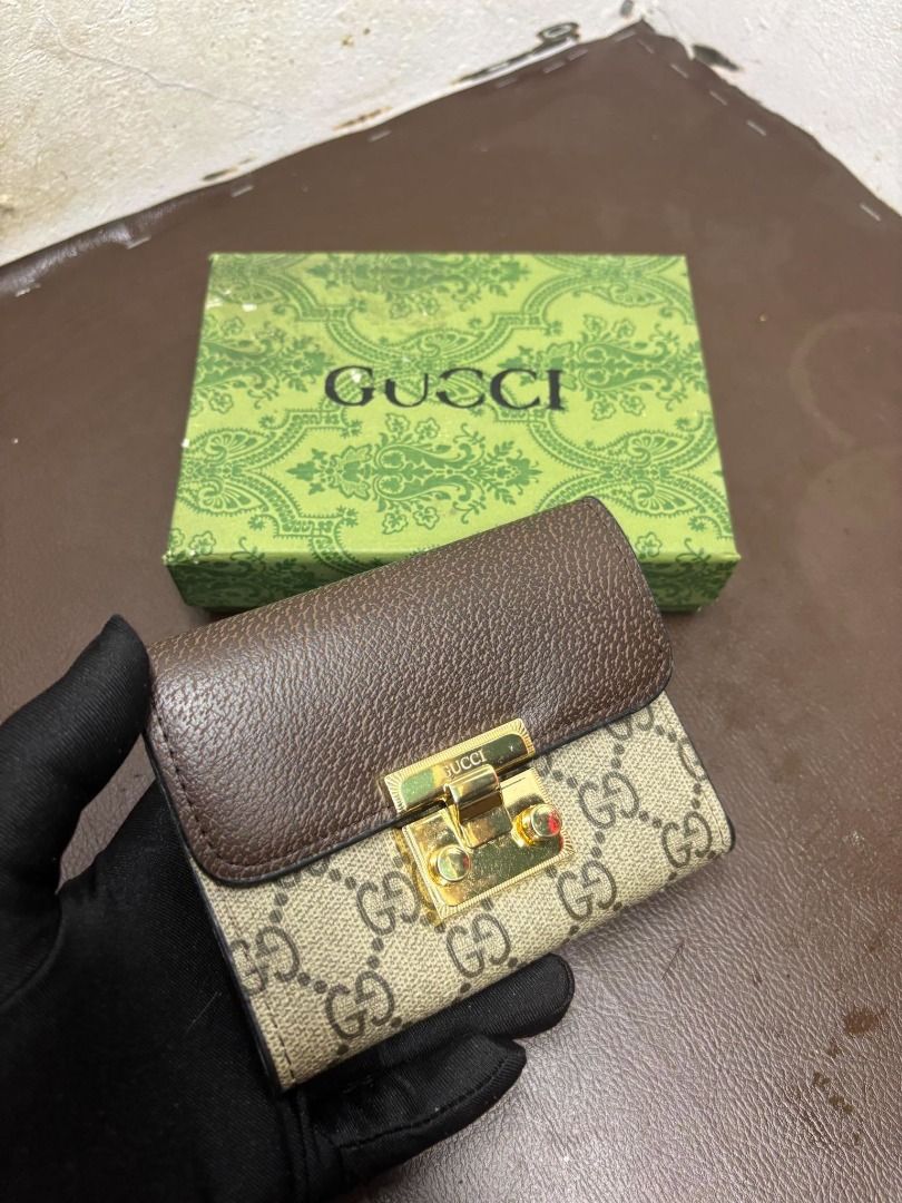 Gucci GG Supreme Padlock Wallet | Brown (Category: Wallets & Card Holders) located in Bacoor. Submitted by fafofa (Listing ID 1465103001, Image 1). Description: Compact Gucci-style wallet featuring GG Supreme coated canvas, a brown leather flap, and a distinctive gold-tone padlock closure. • GG Supreme coated canvas • Brown leather flap • Gold-tone padlock closure • Compact wallet design • Includes box .