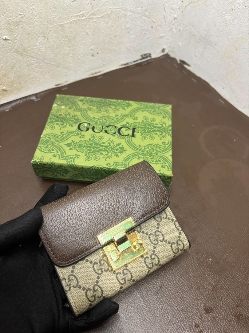 Gucci GG Supreme Padlock Wallet | Brown (Category: Wallets & Card Holders) located in Bacoor. Submitted by fafofa (Listing ID 1465103001, Image 3). Description: Compact Gucci-style wallet featuring GG Supreme coated canvas, a brown leather flap, and a distinctive gold-tone padlock closure. • GG Supreme coated canvas • Brown leather flap • Gold-tone padlock closure • Compact wallet design • Includes box .