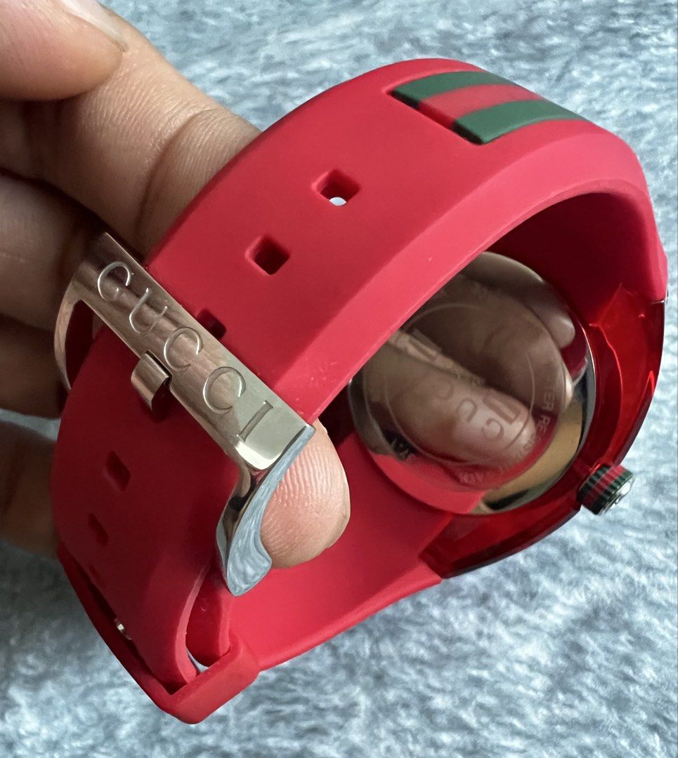Gucci Sync Red Dial Rubber Strap Watch 137.1 (Category: Luxury Watches) located in Manila. Submitted by 2pacquiao (Listing ID 1464976034, Image 3). Description: - Brand: Gucci Sync Quartz Watch (Model 137.1) - Design: Bold red transparent case with matching red rubber strap - Dial: Red sunbrushed dial featuring the iconic interlocking G logo and date window at 4 o'clock - Details: Signature Gucci red and green stripe on the crown and strap - Spec