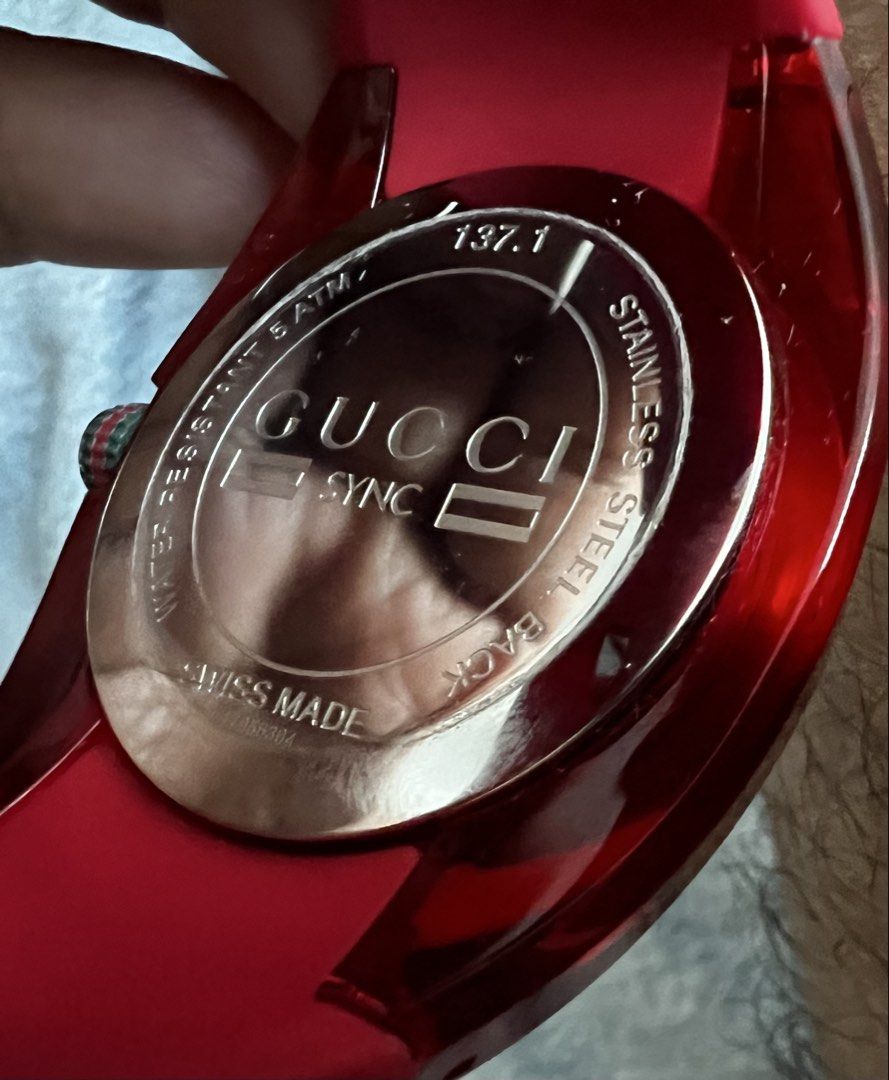 Gucci Sync Red Dial Rubber Strap Watch 137.1 (Category: Luxury Watches) located in Manila. Submitted by 2pacquiao (Listing ID 1464976034, Image 2). Description: - Brand: Gucci Sync Quartz Watch (Model 137.1) - Design: Bold red transparent case with matching red rubber strap - Dial: Red sunbrushed dial featuring the iconic interlocking G logo and date window at 4 o'clock - Details: Signature Gucci red and green stripe on the crown and strap - Spec