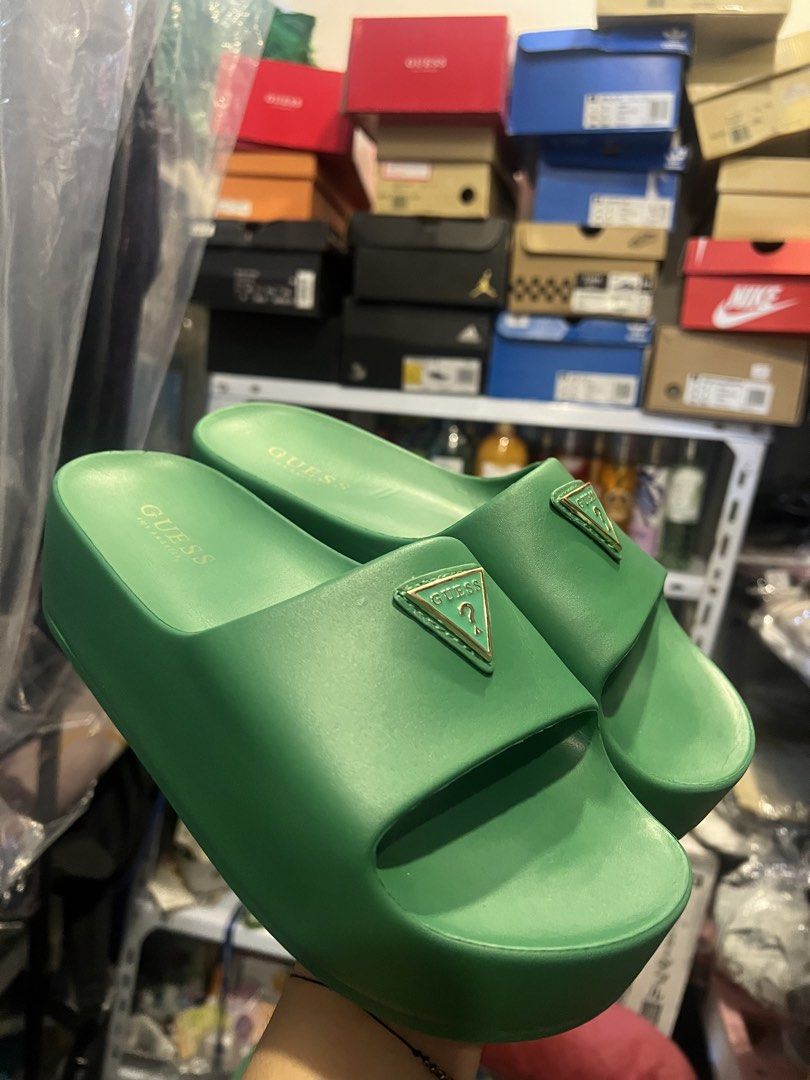 Guess Green Platform Slides (Category: Flats & Sandals) located in Manila. Submitted by cleverstone_21f597 (Listing ID 1464975160, Image 3). Description: - Brand: Guess - Style: Platform slip-on slides with chunky soles - Color: Bright vibrant green - Details: Signature gold triangle logo hardware on the strap - Comfort: Molded footbeds and branded insoles - Condition: Great for casual wear, errands, and lounging.