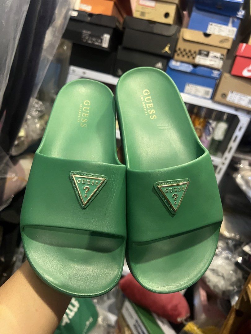 Guess Green Platform Slides (Category: Flats & Sandals) located in Manila. Submitted by cleverstone_21f597 (Listing ID 1464975160, Image 2). Description: - Brand: Guess - Style: Platform slip-on slides with chunky soles - Color: Bright vibrant green - Details: Signature gold triangle logo hardware on the strap - Comfort: Molded footbeds and branded insoles - Condition: Great for casual wear, errands, and lounging.