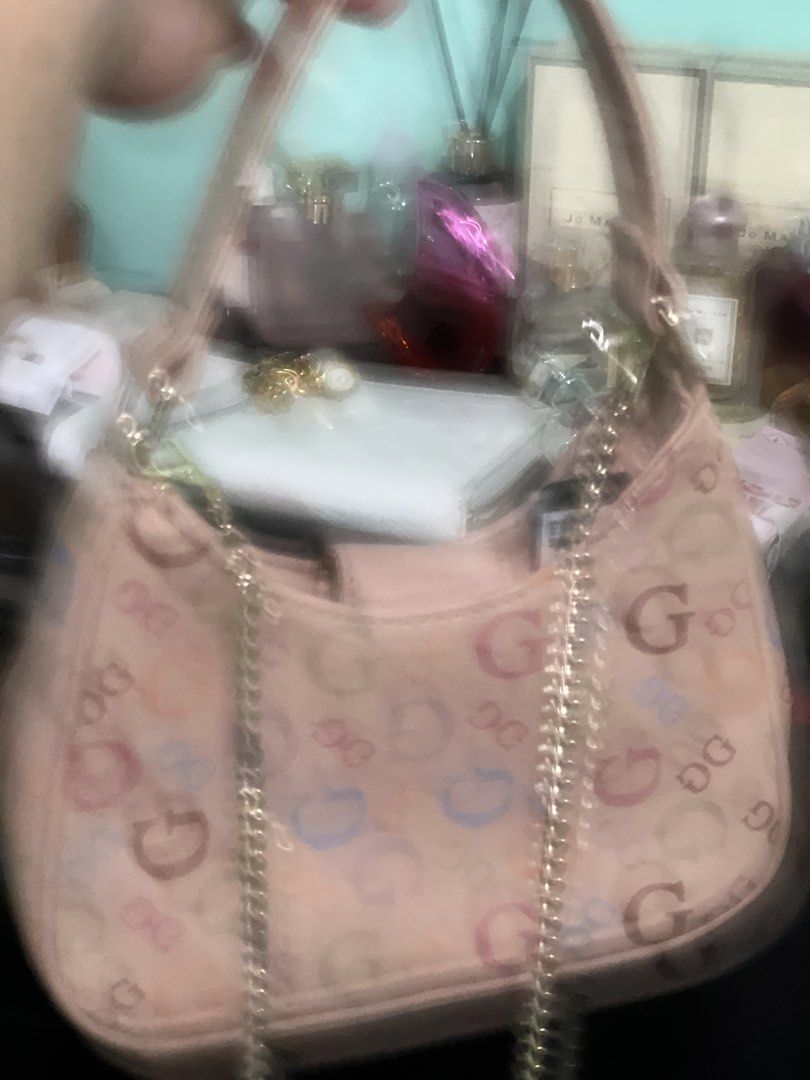Guess Pink Multicolor Logo Shoulder Bag (Category: Shoulder Bags) located in Manila. Submitted by cleverstone_21f597 (Listing ID 1465098695, Image 3). Description: Guess shoulder bag in pink with multicolored logo print all over. Front flap pocket featuring gold-tone hardware and logo plaque. Top handle design with an additional chain strap attached. Structured mini shape, compact size for daily essentials..