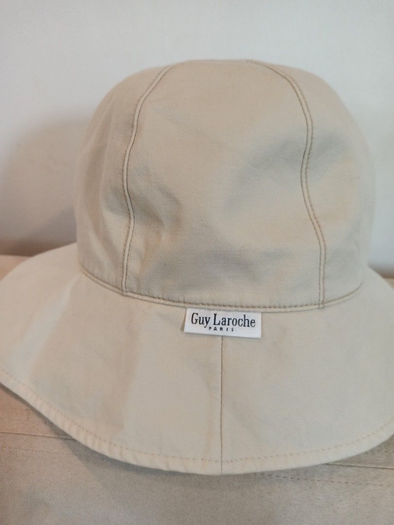 Guy Laroche Paris Beige Bucket Hat (Category: Hats & Beanies) located in Caloocan City. Submitted by rtarellano (Listing ID 1464991991, Image 1). Description: - Brand: Guy Laroche Paris - Color: Versatile neutral beige - Design: Six-panel crown with stylish contrast topstitching - Detail: Branded white fabric label on the side seam - Function: Wide brim design, perfect for sunny outdoor days - Condition: Excellent.