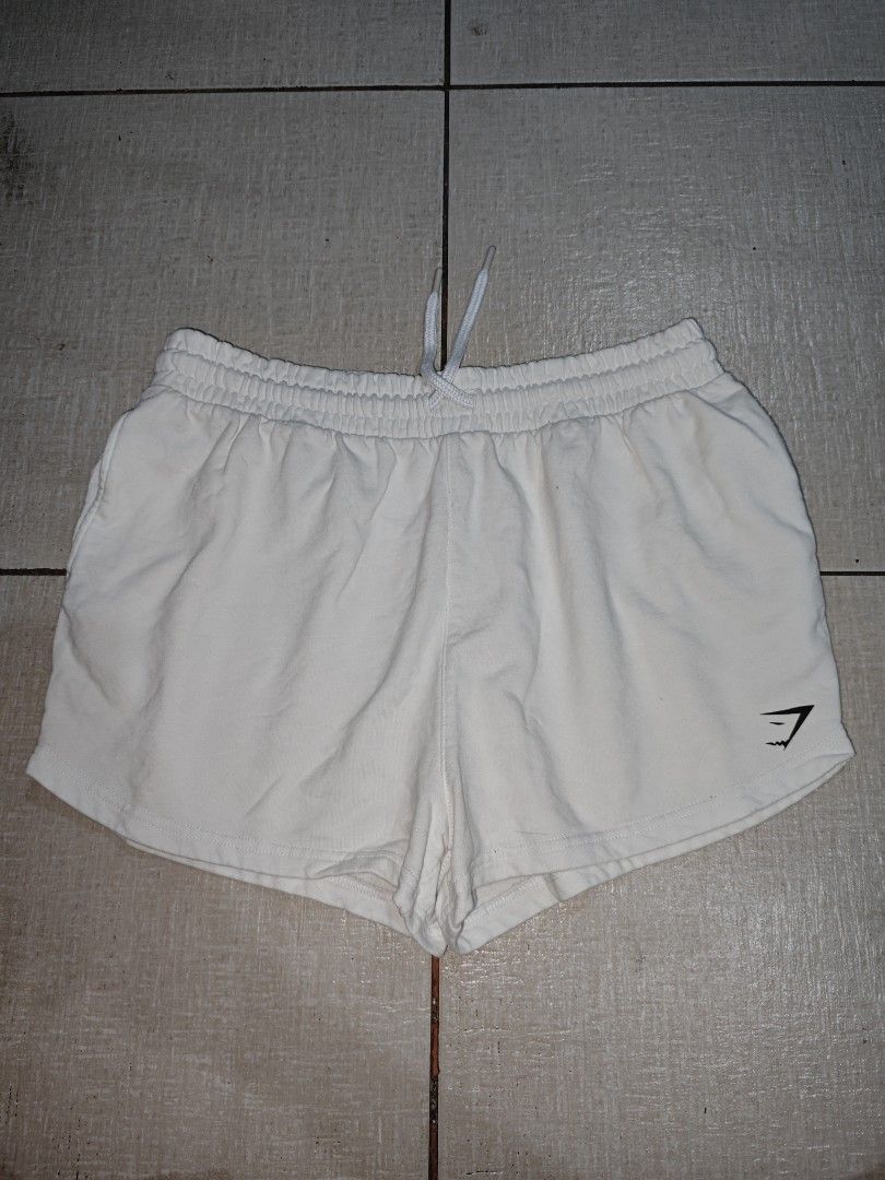 Gymshark White Throw On Shorts Size L (Category: Shorts) located in Manila. Submitted by lilianapat52117 (Listing ID 1465124065, Image 1). Description: GS THROW ON SHORT WHITE LARGE WAIST 31-36 LENGTH 13 VGUC SMALL DIRT 250.