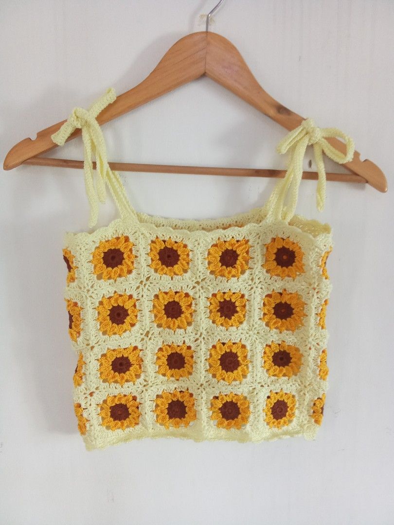 Handmade Sunflower Crochet Crop Top (Category: Sleeveless) located in Manila. Submitted by warmfalcon-9e2e (Listing ID 1465005373, Image 1). Description: - Handmade crochet crop top featuring vibrant yellow, brown, and orange sunflower granny squares - Fully adjustable self-tie shoulder straps for a custom fit - Charming scalloped trim along the top and bottom edges - Lightweight yarn material for all-day comfort - Ideal for summer days, beach tr